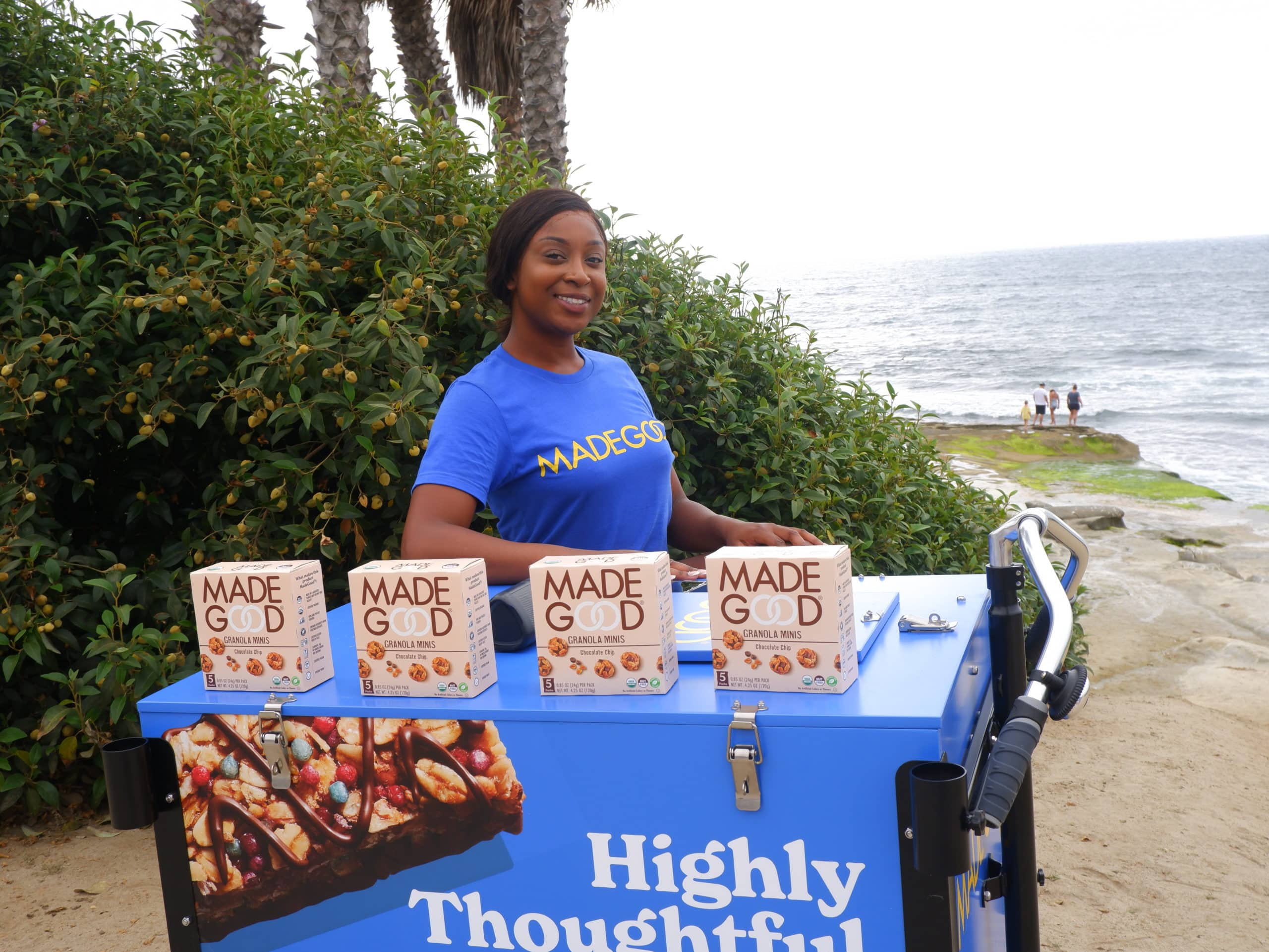 woman with boxes of madegood snacks