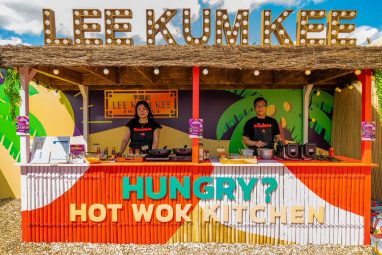 two people cooking in colourful outdoor kitchen