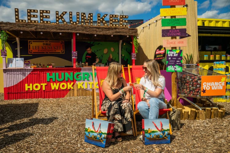 two women sat on beach chairs at a beach bar