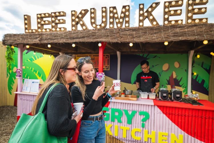 two guests enjoying food at outdoor kitchen