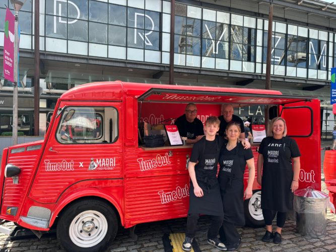 team in front of red food truck