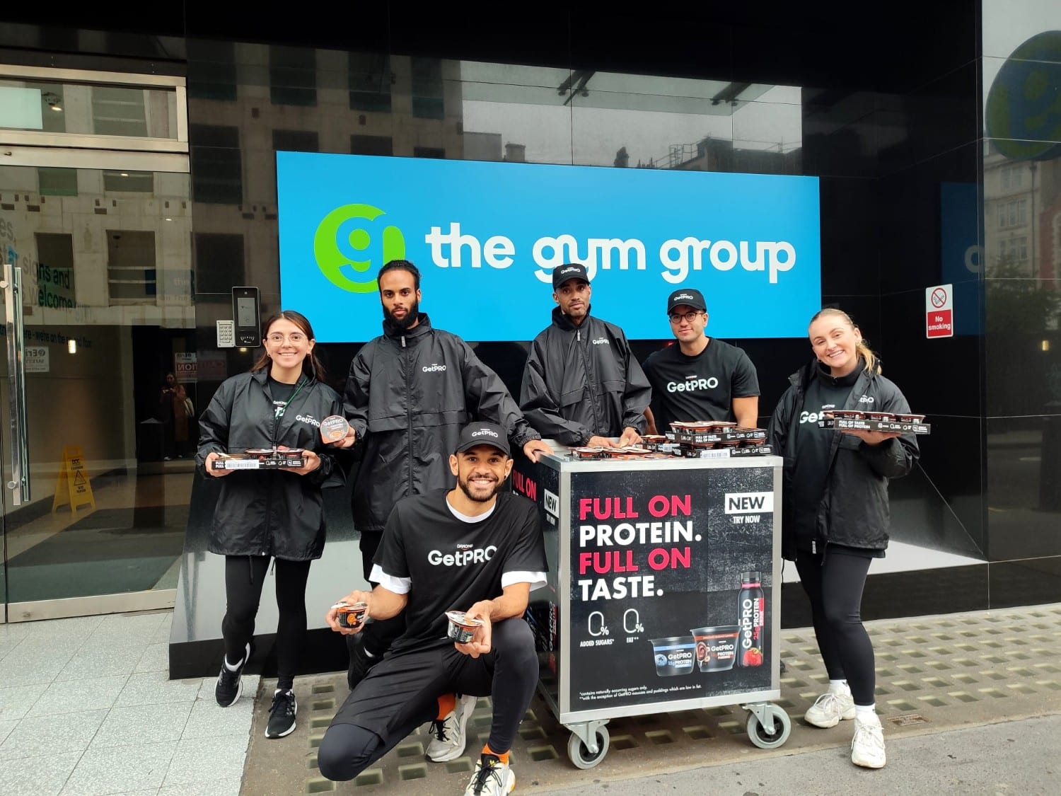 people in black clothes outside a gym